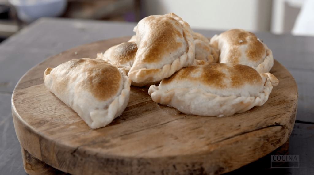 Beef-empanadas-recipe-by-Cocina.</p>
<p>Three beef empanadas are served on a dish. 