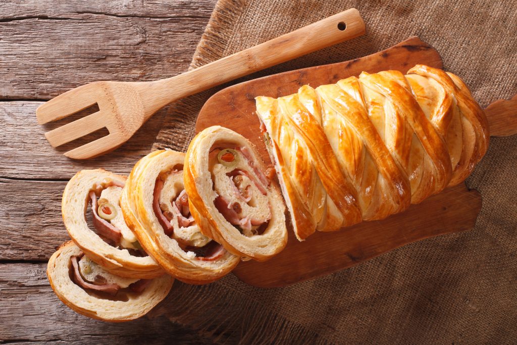 Venezuelan cuisine: Christmas loaf pan de jamon close-up on the table. horizontal view from above