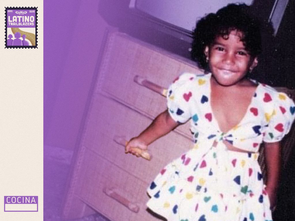 Cris Mercado, part of Latino Trailblazers, smiling to the camera as a young child. 